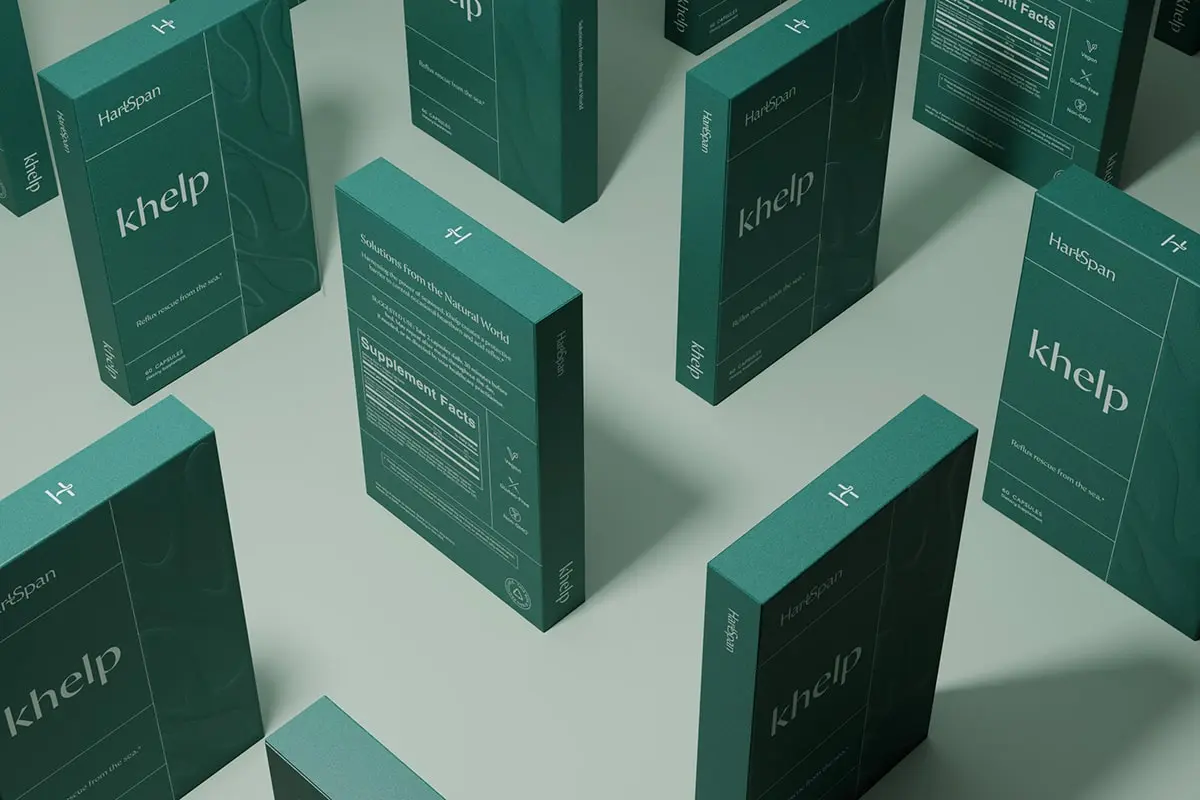 Minimalistic and elegant packaging of HartSpan, by FORNER STUDIO, featuring a soothing color palette with shades of blue and green, representing longevity and natural healing. The design incorporates an organic kelp silhouette, emphasizing the brand's use of natural seaweed ingredients to combat acid reflux, especially during pregnancy.